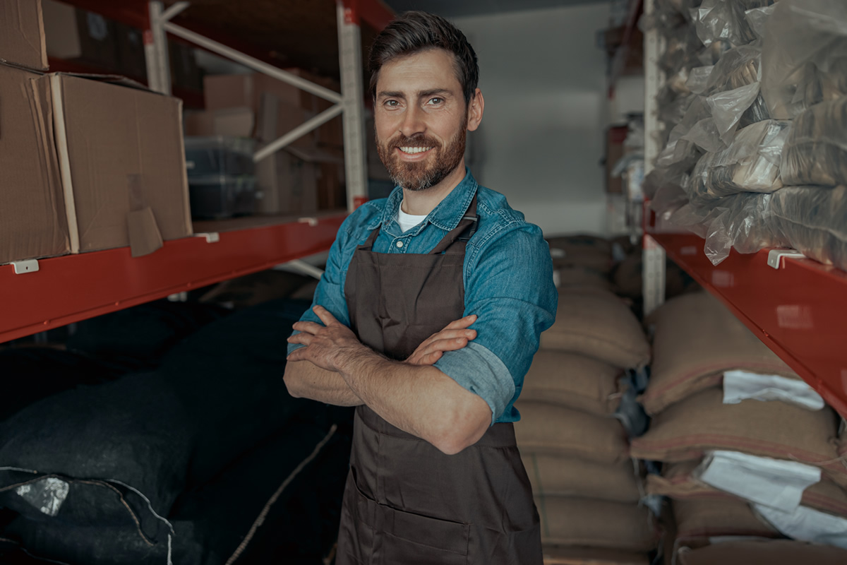 portrait-of-warehouse-worker-in-uniform-of-small-c-2022-08-18-15-11-09-utc